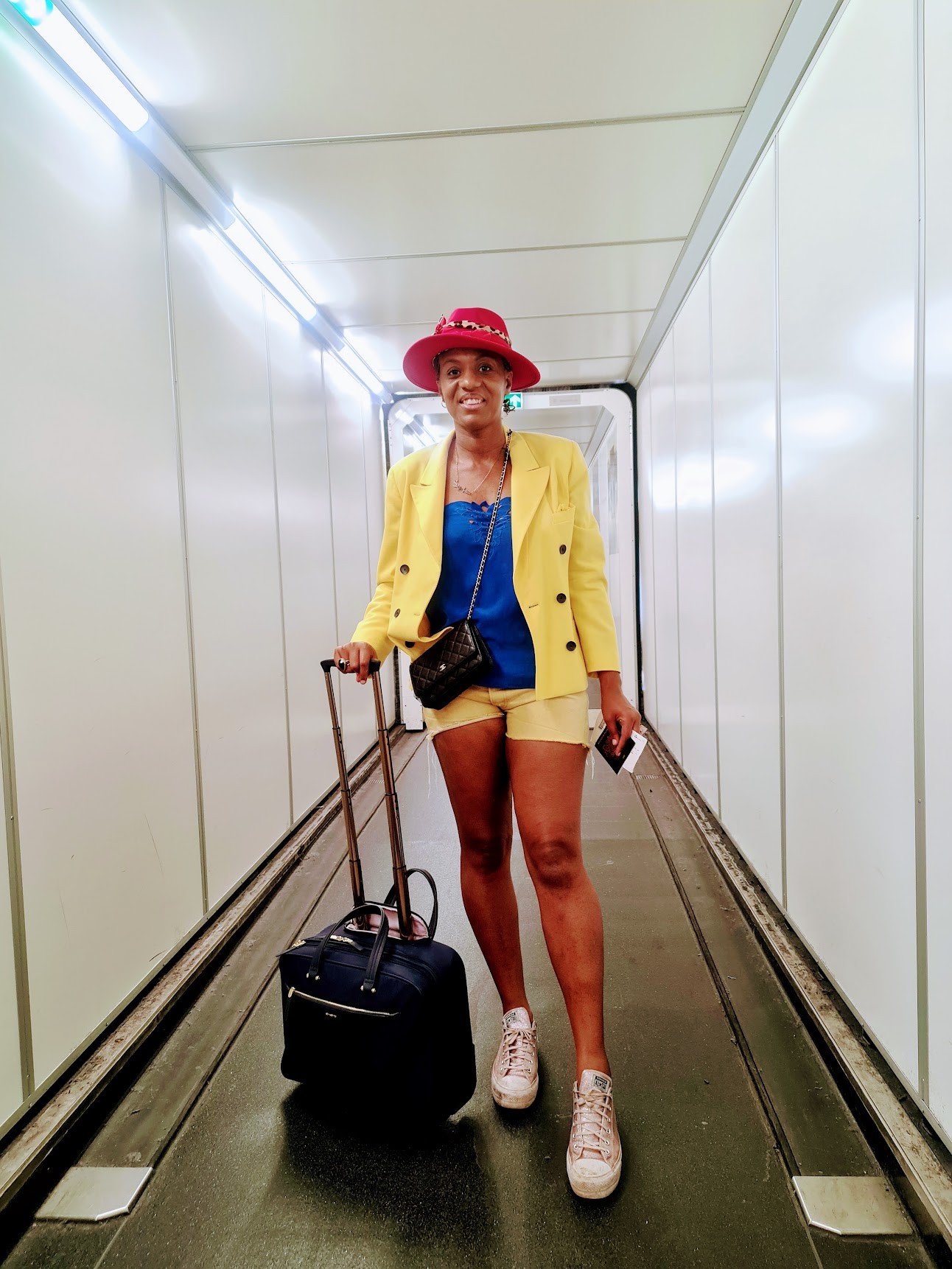 Sophia Husbands standing with her suitcase, ready to travel alone